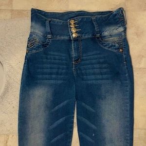 Blue jeans with a brown butterfly on the back